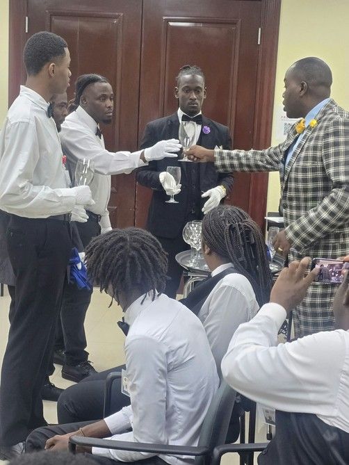 Butler trainees practising glove service