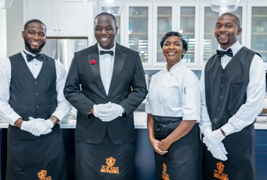 Top Tier Butlers team in white gloves with a chef in a private residence kitchen