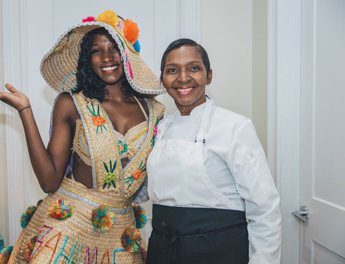Chef with a guest in a traditional Bahamian straw costume